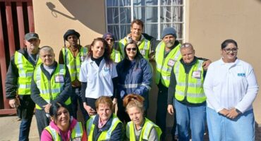 A group of people in safety vests and vests.