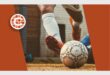 A soccer ball on the ground with a logo on it.