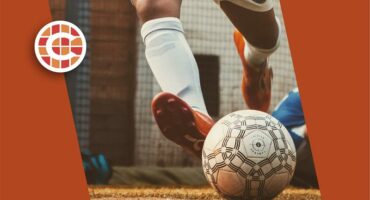 A soccer ball on the ground with a logo on it.