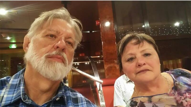 An older couple taking a selfie together.