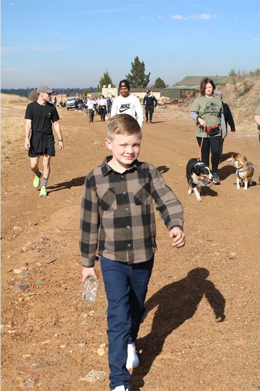 A young boy is holding a bottle of water.