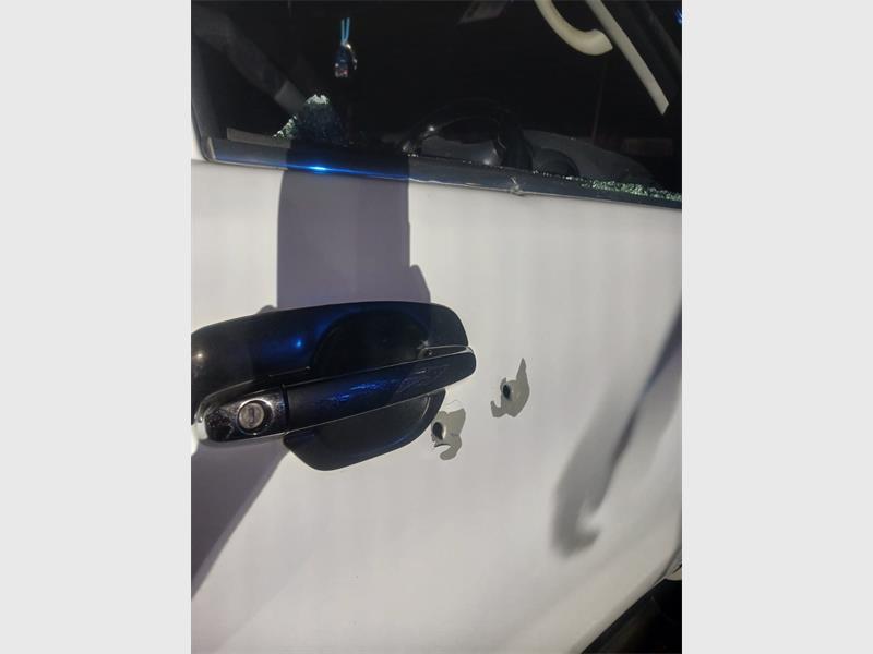 Local police are investigating an attack in which a man was fired upon and dragged into a waiting car. Blood left at the scene suggests he was injured.