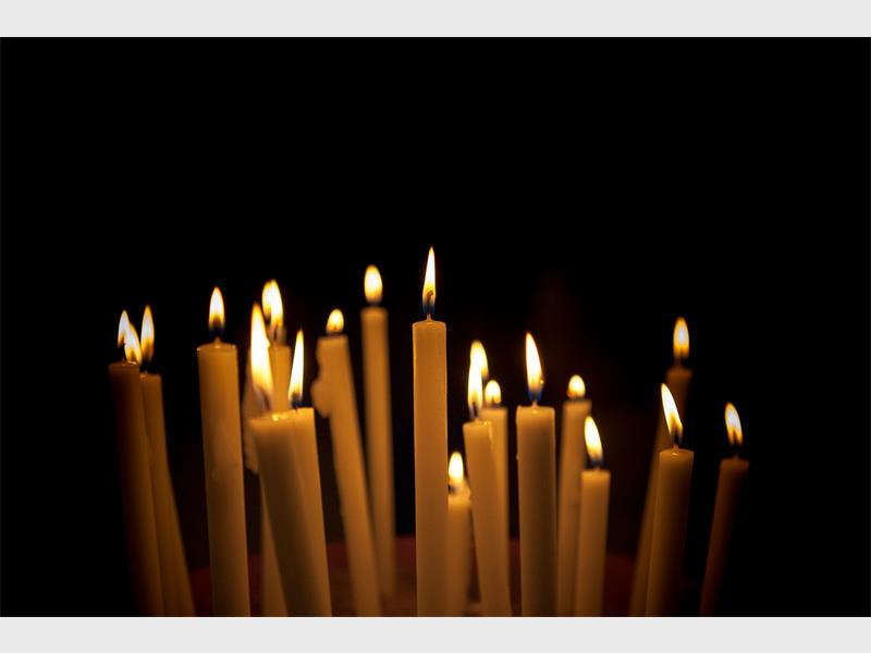 A candlelight service held inside the shack where a woman lost her life became a call to action against gender-based violence and femicide.