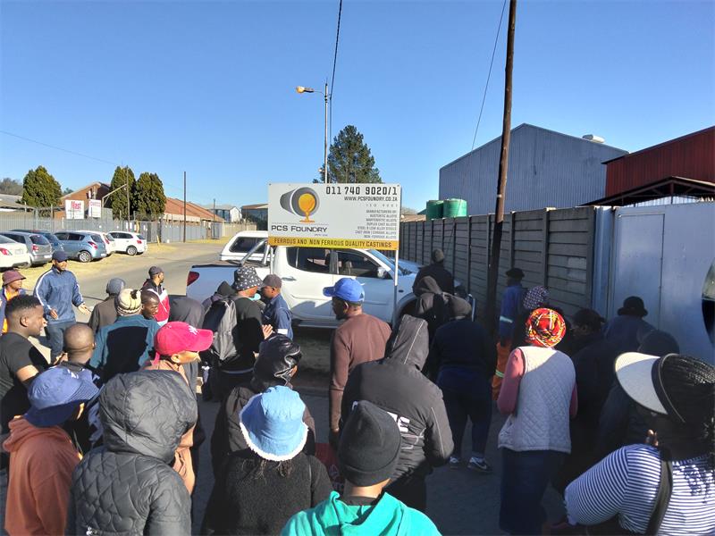 A small group gathered outside the business, where they voiced concerns and attempted to restrict access to the entrance.