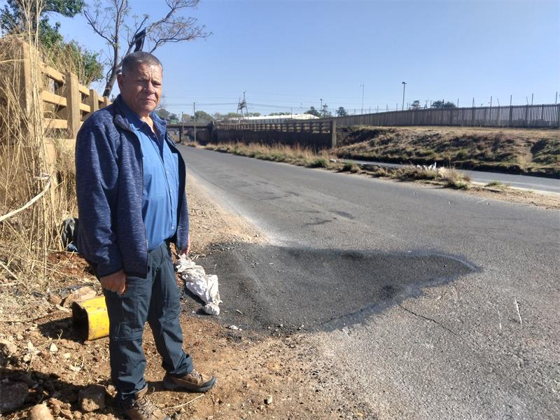 A business owner has questioned why a large pothole was only repaired after an accident, while other potholes along the road remain.