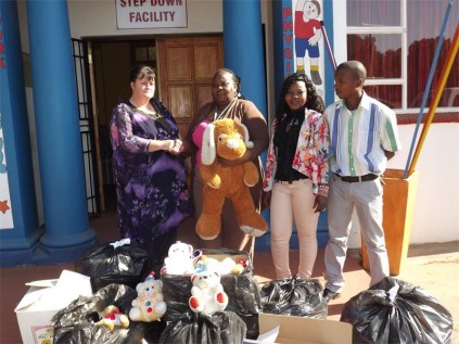 Heila van Loggerenberg and Lucky Rakale from the Rainbow Eduction Centre handing over the donation to Margaret Mashiyane and Emma Mokoena, social workers at the Lonmin House at the Far East Rand Hospital.