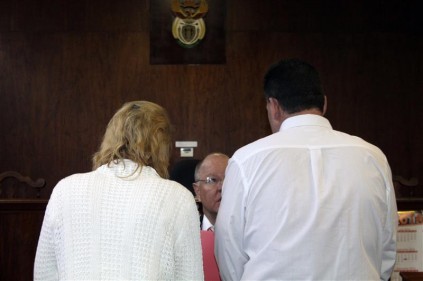 The parents consulting with the mother's lawyer, Boela van der Merwe during their appearance in the Springs regional court on Friday. Their case was postponed to August 22.