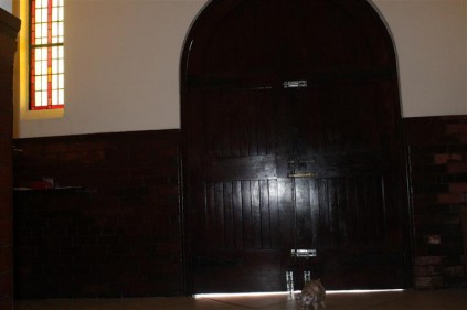 On the inside of the huge wooden front door.