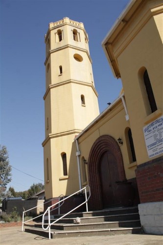 On the outside steps of the church.