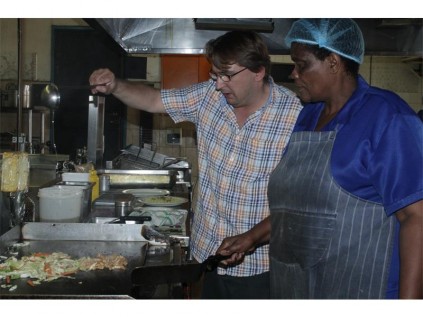 Pink Panther Roadhouse co-owner Denis Fernandes and Eunice Mabiza, one of the cooks, were demonstrating how to make an easy stir fry.