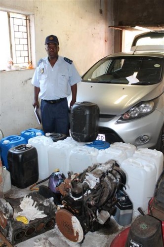 Spokesman for the Springs police Captain Johannes Ramphora with some of the drums and motor used to manufacture the drug.