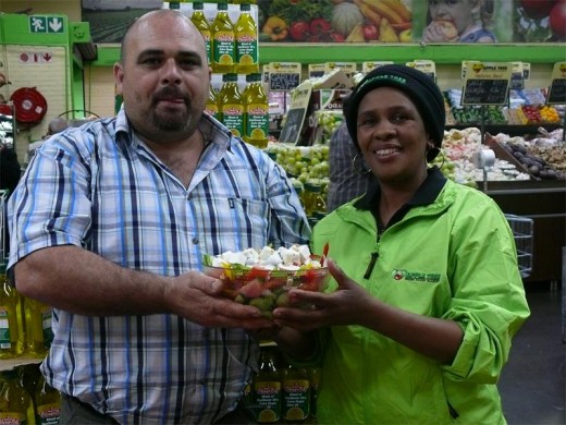 Shane Boucher and Virginia Ndamase from Apple Tree showing off the fresh green salad.