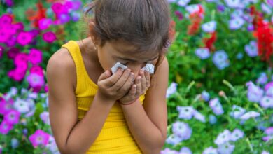 The child is seasonal allergy to flowers. Selective focus. Kid.