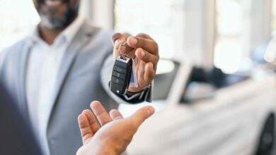 Closeup,Hand,Of,Cardealer,Giving,New,Car,Key,To,Customer.