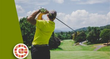 A man is playing golf on a green field.