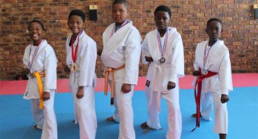 A group of young boys in karate uniforms.