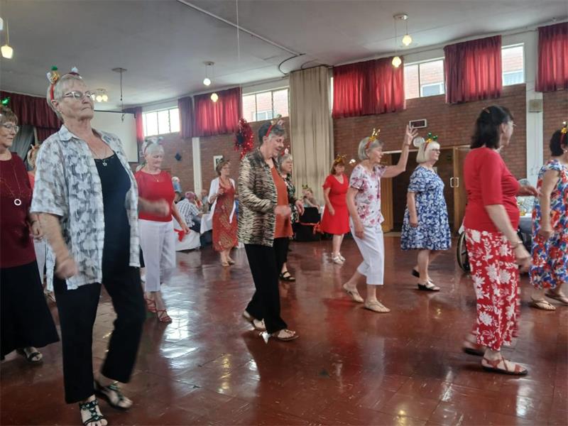 Members enjoyed dancing, carols, and fellowship as the club reflected on achievements and appealed for transport support.
