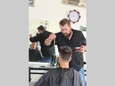 Jannie van der Westhuizen busy giving Jason Robins a funky new hairstyle at his salon, West End Studio in Homelake.