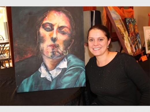 Magriet Botha by een van haar indrukwekkende skilderye.