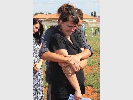 Christene Botha being comforted by her husband, Robert Putter