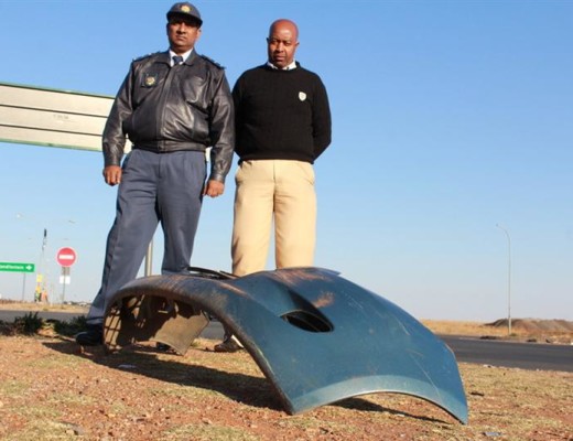 Colonel Selvan Moonsamy, station commander of the Westonaria Police and Sergeant Simon Rakoba at the R28–N12 intersection. On a random visit to the intersection, they found debris from a previous crash at the intersection.