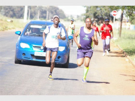 Frans Mola (left) with spectator and fan Dithapelo Tumani, chairperson of Kagiso Striders Athletics Club. Photo: Raymond Moeng