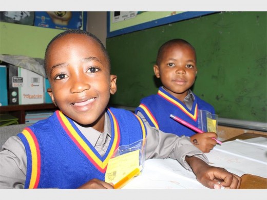 Tlholo Leshomo and Lesedi Baloyi from West Gold hard at work on their first day of Grade 1.