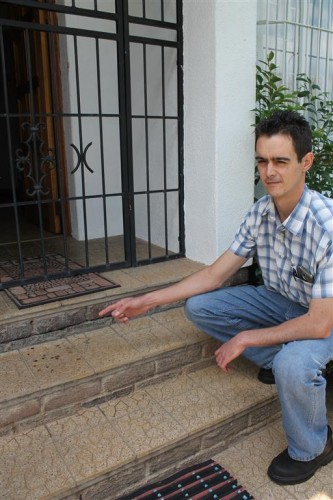 TEIXEIRA points at drops of dried blood where Kruger was shot.