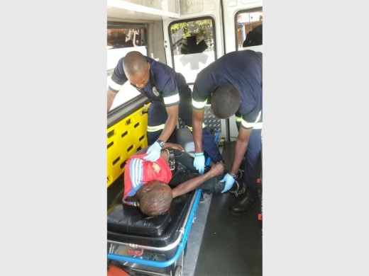 PARAMEDICS treating the injured teenager. Photograph: Norkem SAPS