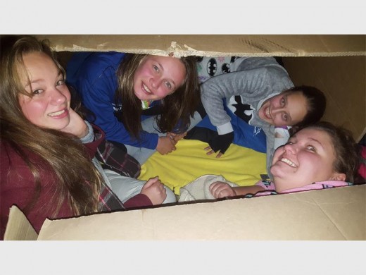 GRADE 7 girls getting settled into their cardboard beds. Photo: provided