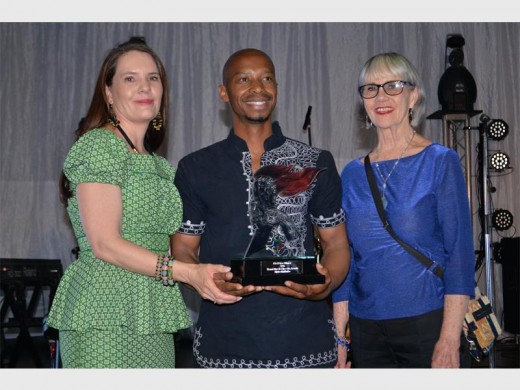 VICTORIOUS Mpho Makhubo posing at the centre with his trophy flanked by Ekurhuleni’s manager of Visual Arts and Crafts Micha Hannekom (left) and the owner of the Lizamore Gallery Teresa Lizamore. (Photograph: Ekurhuleni metro)