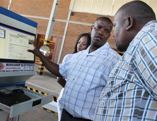 BERNARD Racheku, Management Rep at the Licensing Department) demonstrating to a department official how the machine to test for a vehicle’s brake system is operated.
