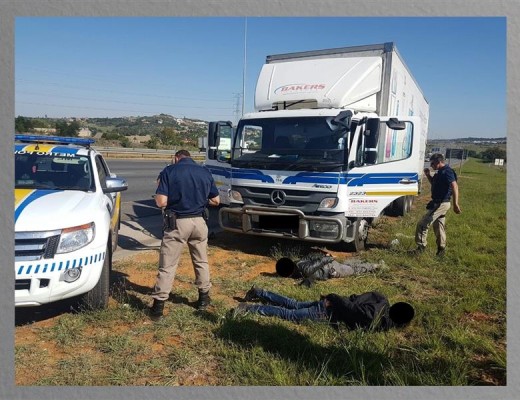 A metro police officer with the two men who have been arrested. Photograph: EMPD