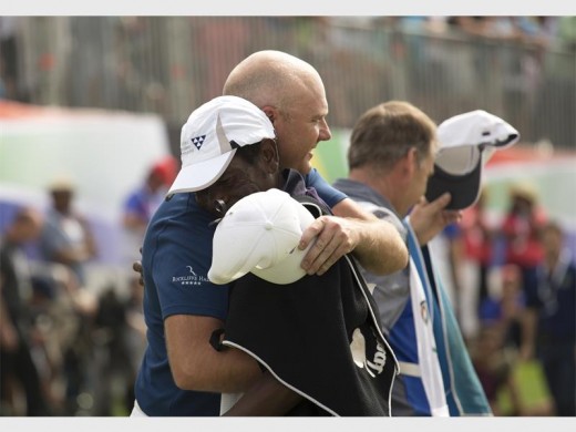 BMW SA Open champion Graeme Storm with his South African caddie, Thama Jeffrey Nkonyane. Photograph: Luke Walker.