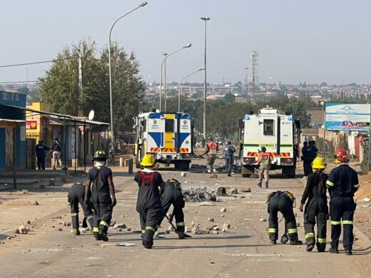 Firefighters work to clear one of the affected roads.