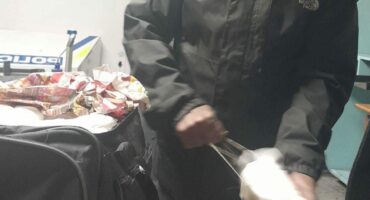 Police officer search a bag at OR Tambo International Airport.