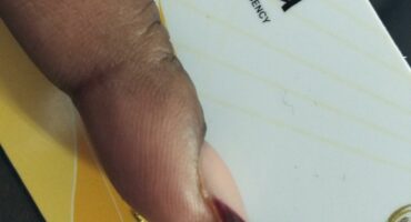 Beneficiary holding her Sassa card. Photo: Kempton Express.