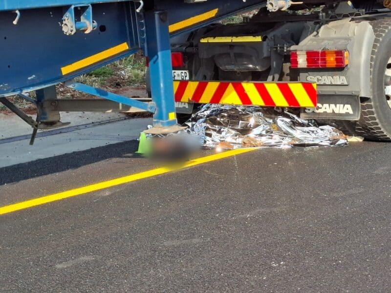 According to DEMS one of the pedestrians was trapped under the truck while the other was lying on the pavement.