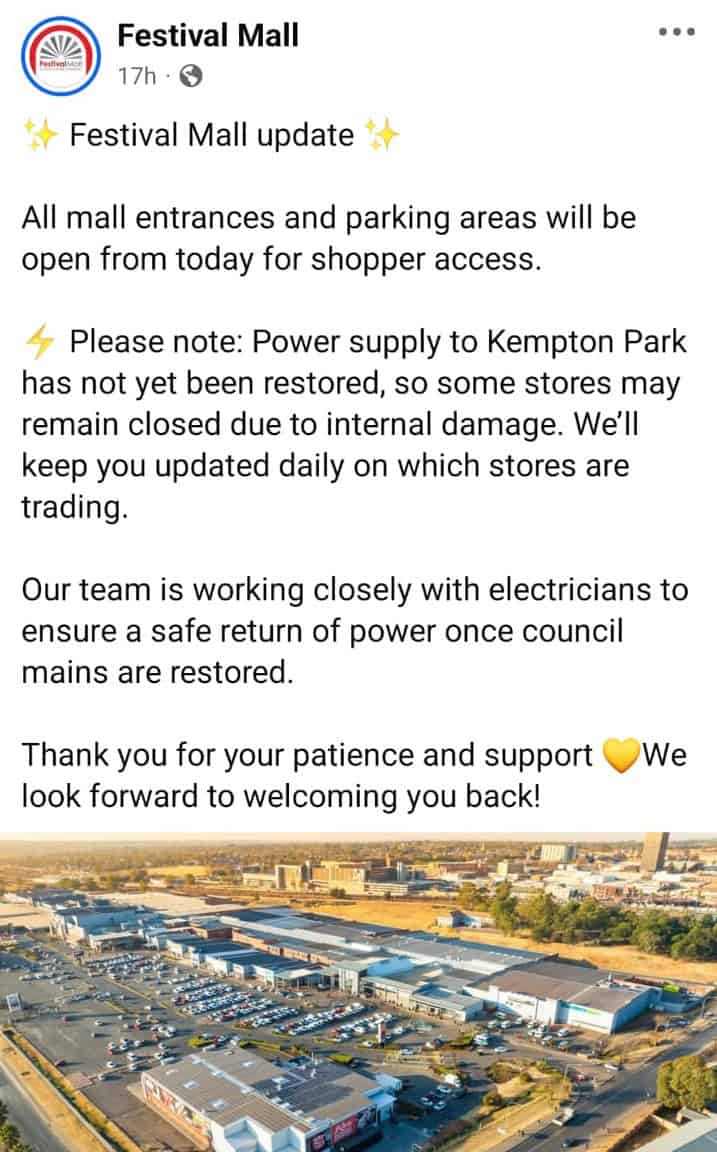Festival Mall Facebook post announcing reopening of entrances and parking. Notes some stores in Kempton Park may remain closed due to power issues. Team working with electricians for safe power restoration. Aerial photo of the mall with parking areas visible. Tone is informative and optimistic.
