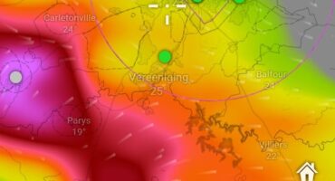 Colorful weather map showing temperature gradients in Johannesburg, from purple to yellow. Green markers indicate different locations. Shows a large storm moving towards Kempton Park.