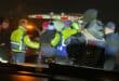 Emergency responders assisting individuals at night, with flashing lights illuminating the scene during a critical situation.