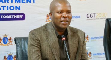 A speaker at a press conference discussing the GGT2030 initiative for Gauteng Province, emphasizing collaboration and growth.