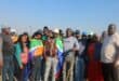 A collective of people standing side by side, proudly displaying flags that represent their identities and beliefs.