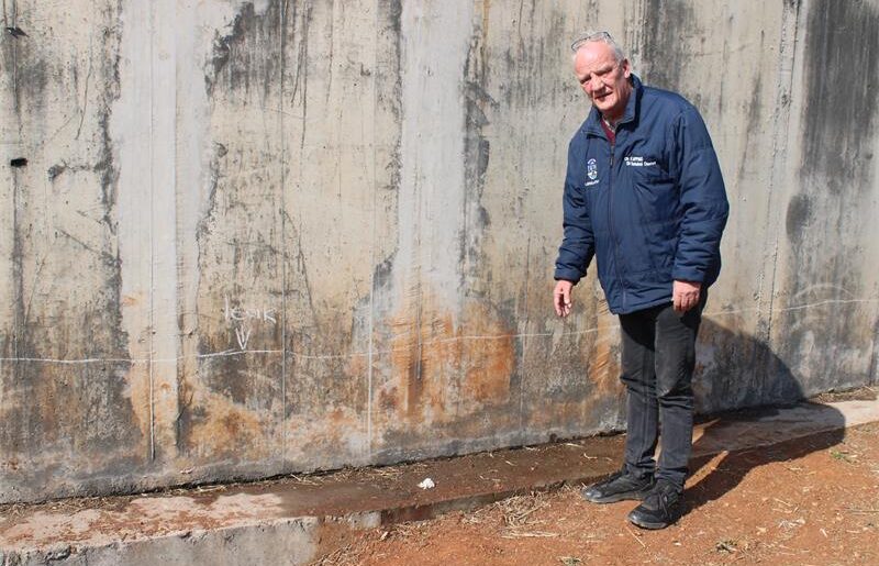 The Isando Reservoir structure seems compromised amid visible water leaks.