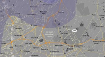 Map of Johannesburg showing suburbs, roads, and a broad purple weather overlay with scattered rain markers; a label reads “0 mm,” suggesting little or no rainfall.