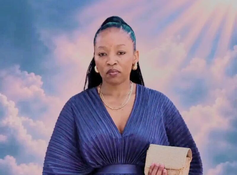 Portrait of a poised Black woman in a pleated blue dress holding a beige clutch, framed by dreamy pink clouds and radiant sunlight.