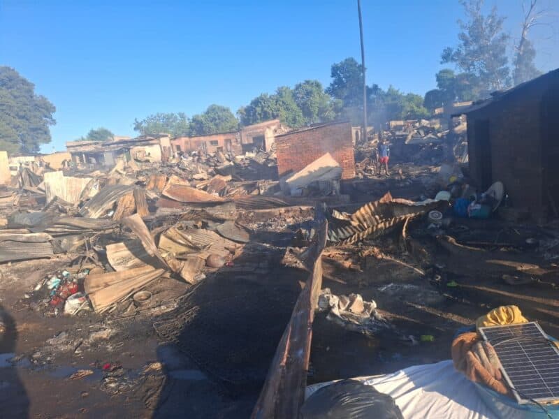 The men died in separate shacks as the fire tore through the settlement, while residents battled to salvage what they could from their burning homes.