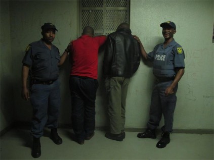 Arresting officers Const Tshepang Motebejane (left) and Sgt Vincent Nkosi, with the two men arrested for possession of dagga, last Tuesday.