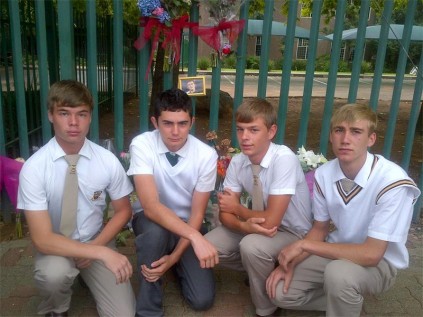 Christiaan Theunissen's rugby friends outside Hoërskool Elsburg, on Thursday, when flowers had been laid for Christiaan. From left are: George Williams, Quinn Sutcliffe, Ruan Ackermann and JP Theunissen (Christiaan's cousin).