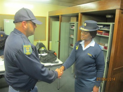 WO Mark Woodley (left), from the Germiston Flying Squad, is congratulated by Brig Phumla Mdlankomo, the Germiston cluster commander, for a job well done.